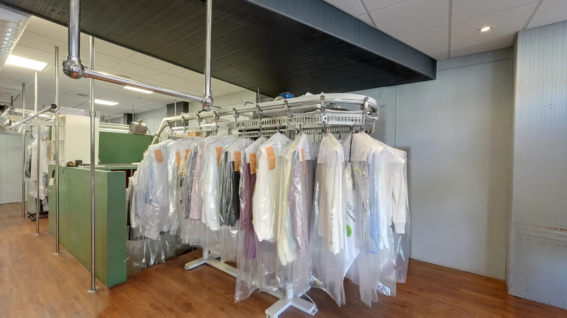 Shirts and garments on the conveyor inside Glenforest Cleaners